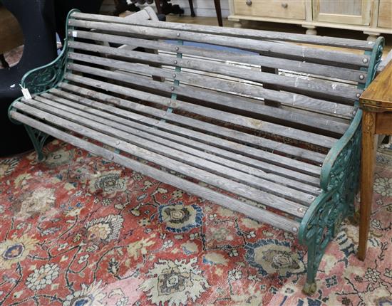 A Victorian green painted wrought iron and teak garden bench and a teak garden bench with slightly curved back W.189 and 183cm